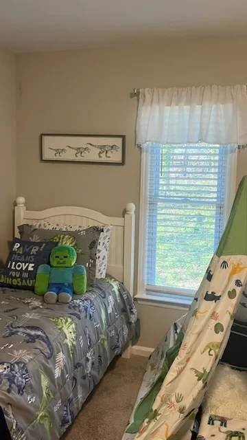 Personalized bedroom with layered bedding and colorful accents