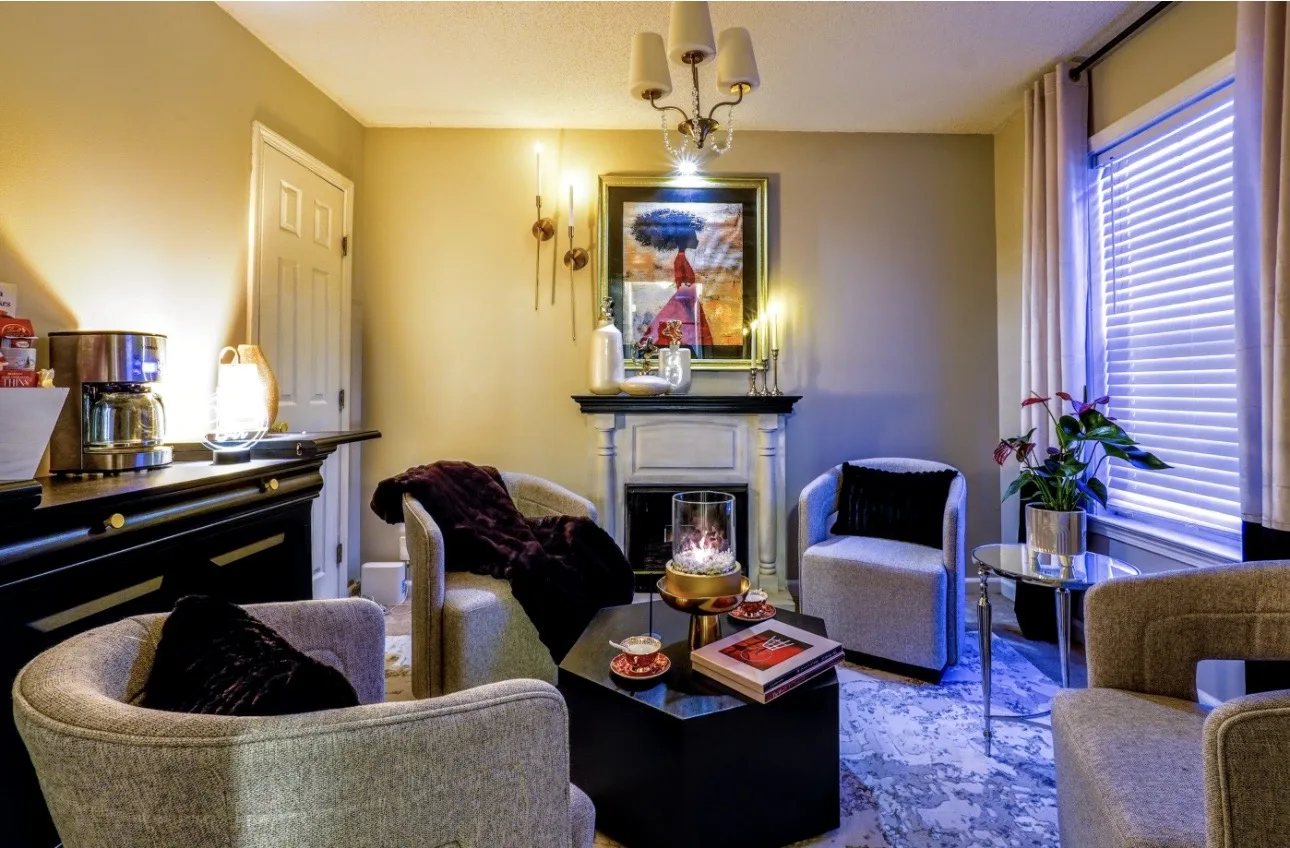 Warm finished living room with seating around a fireplace