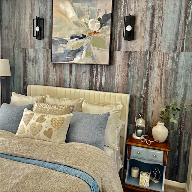 Layered neutral bedroom with a textured wood accent wall